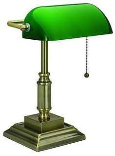 a green table lamp with a chain hanging from it's end on a white background