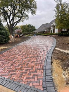 a brick walkway in front of a house