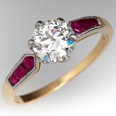 a diamond and ruby engagement ring with two stones on the band, set in yellow gold