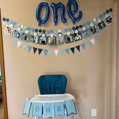 a baby's first birthday party with blue and white decorations, one photo bunting