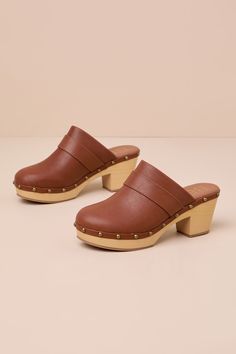 Step into the cutest OOTDs with the Beach by Matisse Maverick Cognac Studded Platform Clogs! Textured faux leather shapes these timeless clogs that feature a rounded toe upper adorned with studded accents and a curved topline with a banded detail, all atop a .75"" toe platform. The slide-on design just wouldn't be complete without a chunky, wood-look block heel! Available in whole sizes only. 2. 5" wood-look block heel. Cushioned insole. Rubber sole has nonskid markings. Man made materials. Impo Platform Clogs Shoes, Platform Clogs, Clogs Shoes, Casual Fit, Summer Essentials, Casual Fits, Shoe Sale, Cognac, The Cutest