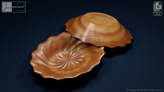 two wooden bowls sitting on top of a black table next to each other, one is shaped like an oyster