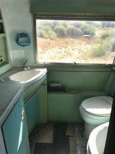 a bathroom with a sink, toilet and window