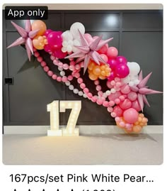 the number 17 is decorated with pink and white balloons, starbursts, and streamers