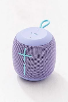 the bluetooth speaker has a cross on it's front end and is connected to a cord