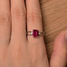 It is a lab ruby ring. The main stone is 6 mm*8 mm emerald cut.weight about 1.7 carats. The basic metal is sterling silver and plated with rhodium. To change the metal to a solid gold (white/rose) or platinum is also available, please ask for a quotation if you want. You can also go to my shop Home for more elegant rings: https://www.etsy.com/shop/godjewelry?ref=hdr_shop_menu Ruby is July birthstone More ruby rings: https://www.etsy.com/shop/godjewelry?ref=seller-platform-mcnav&section_id=20 Red Ruby Ring, Elegant Rings, Red Gemstone Ring, January Birthstone Rings, Red Garnet Ring, Star Garnet, Ring Emerald Cut, Silver Anniversary, Real Jewelry