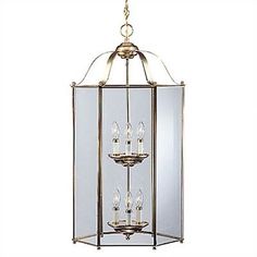 a light fixture hanging from the ceiling with four lights on each end and one candle in the