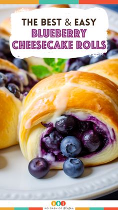 the best and easy blueberry cheesecake rolls on a plate with fresh blueberries