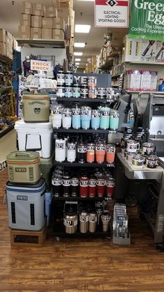 there are many different items on display in the store, including coffee mugs and coolers