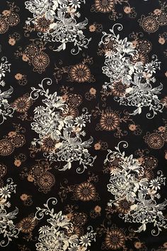 black and white floral print fabric with gold accents on the bottom half of the image