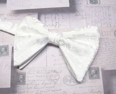 "Beautiful pre-tied, adjustable double tiered banded bow tie.  It will adjust from 13\" through 20\" neck. Bow dimensions 3.25\" x 4.5\"." Classic Pre-tied Bow With Butterfly Knot, Classic White Adjustable Bow Tie, Elegant White Adjustable Bow Tie, Adjustable White Bow Tie With Decorative Bow, Classic White Bow With Butterfly Knot, Adjustable White Bow For Black Tie Occasion, Classic Adjustable Bow With Detachable Feature, Elegant Pre-tied Bow For Gift, White Adjustable Bow With Butterfly Knot