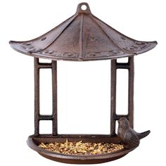 a metal bird feeder with two birds eating out of it's top and bottom