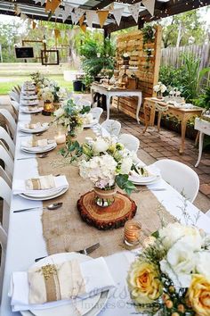 an outdoor dining area with tables and chairs set up for a wedding or other function