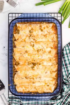 a casserole dish on a cooling rack with green onions