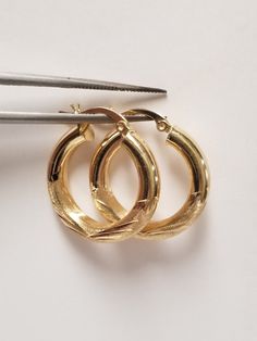 "Thanks for shopping our vintage estate store. We tend to sell well below wholesale and truly hope you enjoy all of our items. Many of the items are one of a kind, so please enjoy scrolling through the pictures and hopefully something will catch your eye. Brown spots are from camera or reflections. Beautiful estate 14k yellow gold medium diamond cut hoops. As you can see by the weight these are nice, hoops, no dings only reflections. Retails $649 on sale $229 Length: 1\" Width: 3/4\" across Thickness: 4mm 1/4\" Weight: 2.50 grams These are nice hoops, didn't seen any dings. Marked 14k and testing to be 14k." Classic 14k Stamped Hoop Earrings, Elegant Small Hoop Clip-on Earrings For Anniversary, Antique Hallmarked Earrings For Anniversary, Classic Clip-on Hoop Earrings As Gift, Classic Polished Earrings For Anniversary, Classic Polished Finish Earrings For Anniversary, Vintage Yellow Gold Jewelry With Matching Earrings, Heirloom Oval Gold Earrings, Classic Anniversary Earrings With Polished Finish