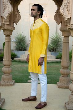 Lime yellow kurta with off white thread work on yoke ,sleeves and side cuts. Paired with white pant.
Components: 2
Pattern: Embroidered
Type Of Work: Thread
Neckline: Mandarin
Sleeve Type: Full
Fabric: Chanderi silk
Color: Yellow
Other Details: 
Front buttons
Occasion: Wedding - Aza Fashions Yellow Kurta, White Pant, Lime Yellow, Side Cuts, Thread Work, Silk Thread, Pant Set, White Pants, Embroidered Silk