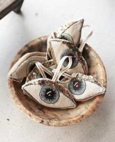 two pairs of blue eyes are in a wooden bowl