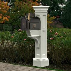 a white mailbox sitting on the side of a road