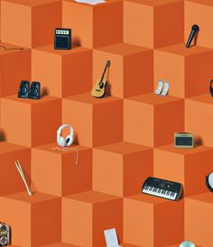 an orange wall with many different items on it, including headphones and music equipment