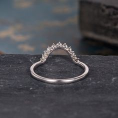 a diamond ring sitting on top of a rock