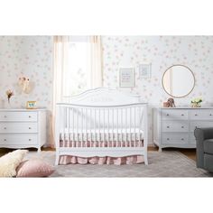 a baby's room with floral wallpaper and furniture