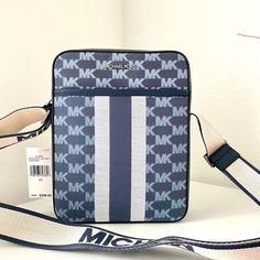 100% Michael Kors Authentic Guarantee And Firm Price! Details Leather/Canvas Silver Tone Hardware 7.5”L X 9.5”H X 2.5”D Zip Fastening Imported Casual Michael Kors Rectangular Bag, Blue Rectangular Coated Canvas Shoulder Bag, Blue Coated Canvas Shoulder Bag With Branded Hardware, Blue Travel Bags With Logo, Blue Logo Travel Bags, Blue Travel Bag With Logo, Blue Coated Canvas Bags With Branded Hardware, Blue Rectangular Bag With Logo, Blue Rectangular Shoulder Bag With Logo