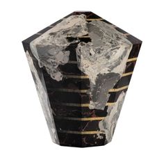 a black and white marble vase with gold trimmings on the sides, sitting against a white background