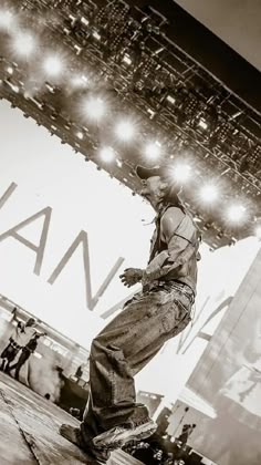 a man riding a skateboard on top of a wooden platform in front of a stage