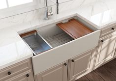 a kitchen sink with two wooden trays on the bottom and one in the middle