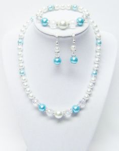 "White w/Turquoise Glass Pearl w/Rondelle Crystal Rhinestone Necklace/Bracelet/Earrings Set This necklace sets is made with lustrous white 8/10/12mm Darice glass pearls, 8/10mm turquoise glass pearls, sparkling 6mm wavy Rondelle crystal rhinestone beads, 10mm crystal faceted glass beads and Czech crystal silver lined seed beads strung on flexible beading wire. The necklace measures approximately 17\" (plus a 3\" extension chain) in length and fastens with silver lobster clasp. It comes with brac Turquoise Beaded Crystal Jewelry, Beaded Turquoise Crystal Jewelry, Adjustable Turquoise Crystal Jewelry, Elegant Beaded Pearl White Jewelry, Silver Pearl Beaded Jewelry Sets, White Beaded Jewelry Sets, Handmade Pearl Jewelry Sets For Wedding, Handmade White Pearl Jewelry Sets, Elegant Turquoise Round Jewelry Sets