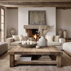 a living room filled with furniture and a fire place next to a couch in front of a fireplace