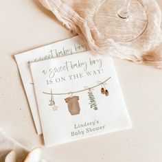 a card that says, sweet baby boy is on the way with clothes hanging from a line