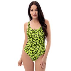 Dive into a rebellious summer with Goth Cloth Co.'s Lime Skull One-Piece Swimsuit. Featuring a daring pattern of skull and crossbones on a lime green background, this swimsuit blends gothic elegance and punk rock flair, perfect for beach and poolside adventures. Key Features: Chlorine-resistant fabric: Made from 82% polyester and 18% spandex for durability. Cheeky fit: With a scoop neckline and low scoop back for a flattering look. Zig-zag stitching: For added durability and style. Double-layer Green Fitted Swimwear For Surfing, Green Summer Bodysuit For Surfing, Green Bodysuit For Surfing In Summer, Green Surfing Bodysuit For Beachwear, Green Bodysuit For Surfing In Beach Season, Green Bodysuit For Surfing During Beach Season, Green Rave Swimwear, Green Bodysuit For Surfing, Green Stretch Bodysuit For Surfing