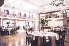 a banquet hall with tables and chandeliers set up for an event or function