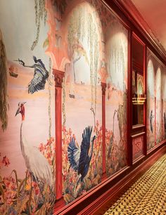 the hallway is decorated with colorful wallpaper and paintings