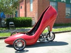 a red high heeled shoe shaped like a car