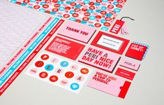 various stickers, tags and envelopes on a white surface with red and blue accents