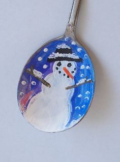 a spoon with a painted snowman on it