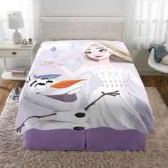 a bed with a frozen princess comforter and pillow set on top of the bed