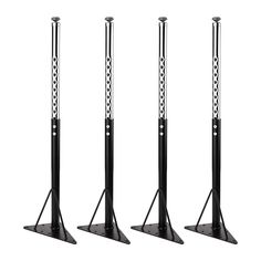 three black stands with white designs on the top and bottom, each holding two microphones