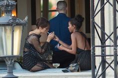 two women sitting on the steps talking to each other