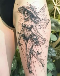 a woman's thigh with a tattoo design on her leg and the image of a fairy