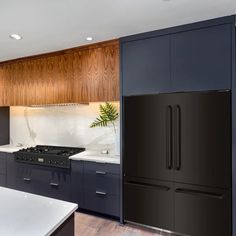 a kitchen with an oven, refrigerator and counter tops in the center of the room