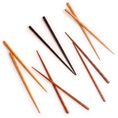 six wooden knitting needles lined up in a row