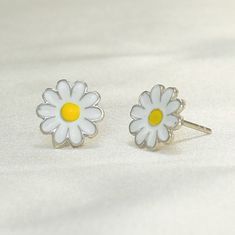 "This stunning 925 sterling silver daisy flower push back stud earrings and necklace set is the perfect gift for any woman who loves sunflowers, nature, or simply beautiful jewelry. The set is made with high-quality sterling silver and features delicate sunflower designs. The earrings feature a single sunflower design with a push back closure. The necklace features a pendant with a larger sunflower design on a delicate chain. The sunflowers are both adorned with sparkling cubic zirconia stones, Cute Silver Flower Earrings, Mother's Day Sterling Silver Flower Earrings, Mother's Day Sterling Silver Birth Flower Earrings, Cute Flower Shaped Jewelry For Mother's Day, Cute White Sterling Silver Jewelry, Silver Daisy Jewelry Gift, Silver Daisy Jewelry For Gift, Sunflower Design Jewelry For Mother's Day, White Birth Flower Earrings In Sterling Silver