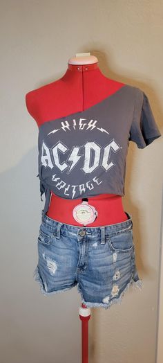 Upcycled AC/DC t shirt. Great for a music festival or event, Coachella, Knotfest, or Bike Week. this is a size medium (size tag pictured), but now that the side has been cut, it's adjustable to your size. Edgy Fitted T-shirt For Music Festival, Edgy Festival T-shirt With Crew Neck, Summer Distressed Band Merch T-shirt, Edgy Screen Printed T-shirt For Summer, Punk Style Screen Print Tops For Summer, Summer Punk Tops With Screen Print, Punk Style Summer Tops With Screen Print, Summer Punk Style Screen Printed Tops, Summer Graphic Tee With Band Logo