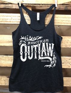 Country Deep American Outlaw racer back tank top Country Deep tank top Next Level Racer back tri blend tank top, 4.3 oz. 50% Poly 25% Cotton 25% Rayon; fits 1/3 size bigger than normal size for a looser fit Fitted Racerback T-shirt For Summer, Casual Pre-shrunk Racerback Tops, Fitted Racerback Casual T-shirt, Summer Sports Racerback T-shirt, Summer Racerback T-shirt For Sports, Fitted Racerback Tops With Letter Print, Fitted Racerback Tank Top With Graphic Print, Fitted Racerback Vest With Graphic Print, Summer Workout Racerback T-shirt