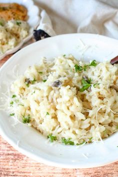 a white plate topped with rice and parmesan cheese