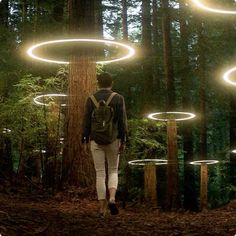 a person with a backpack walking through a forest filled with trees covered in glowing circles