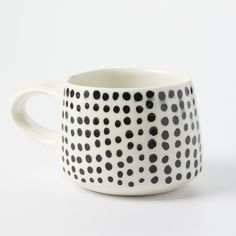 a black and white polka dot coffee cup